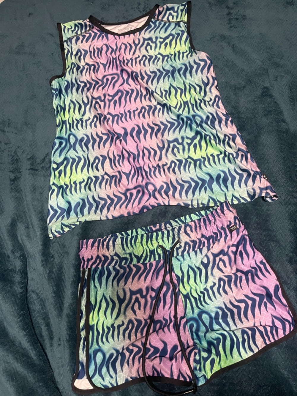 TomboyX Head Over Eels" set vibrant, multi-colored zebra-like print